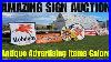 Searching_For_Deals_At_An_Estate_Auction_Full_Of_Vintage_Advertising_Signs_01_qepd